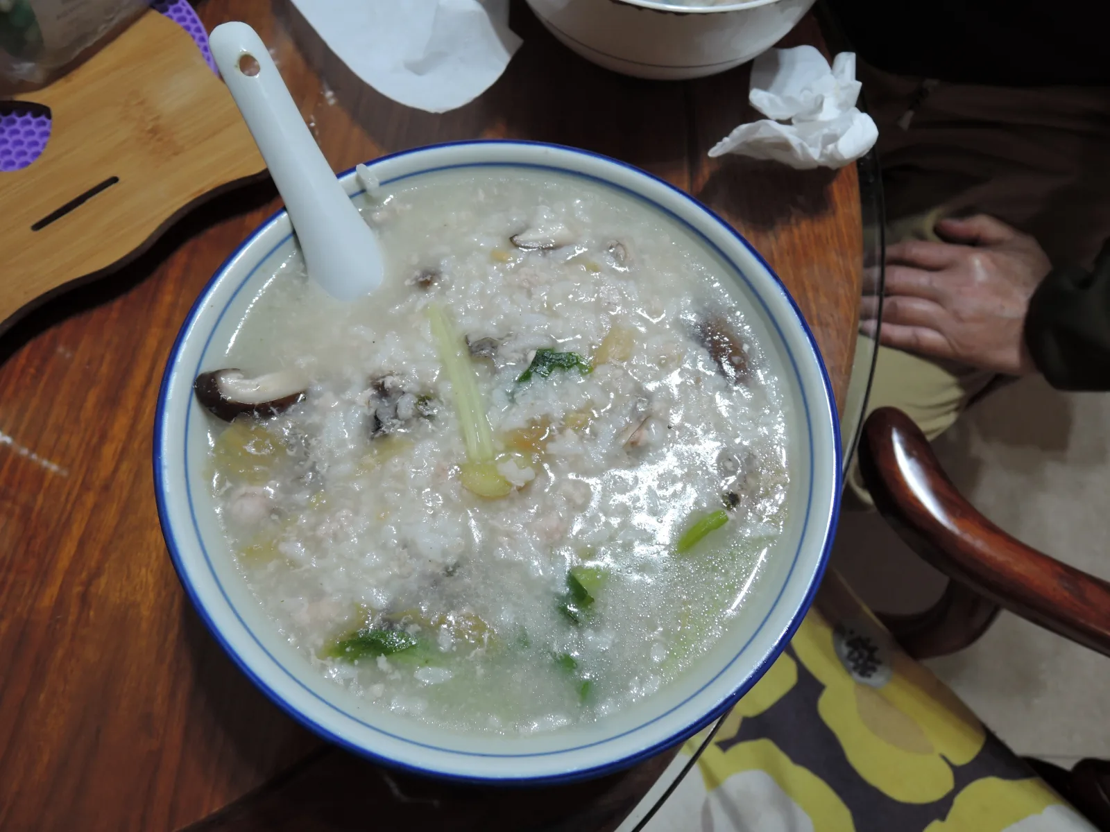 A bowl of homemade Cantonese congee with vegetables and savoury toppings