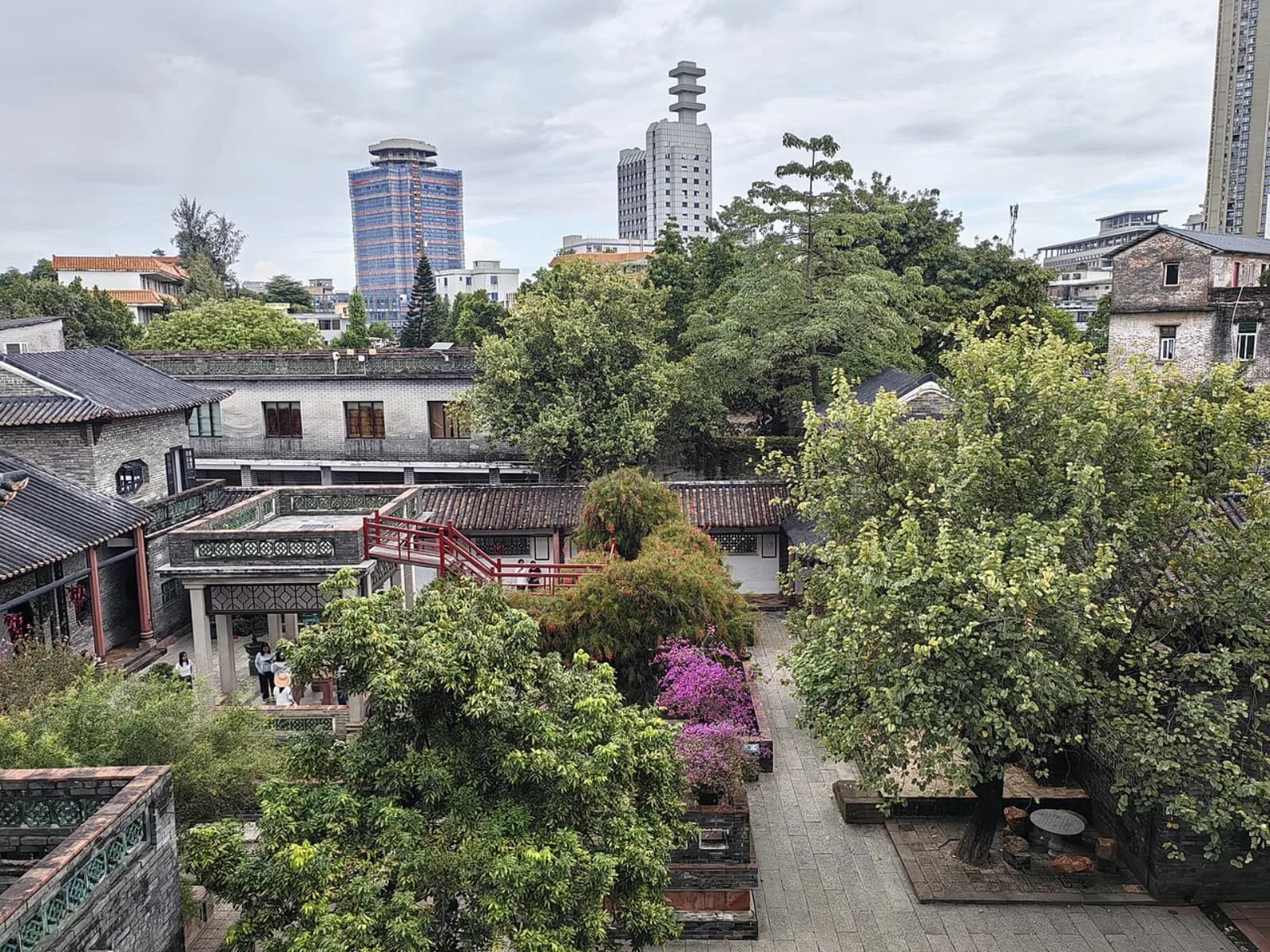 Keyuan's tiled roofs with modern Dongguan buildings beyond