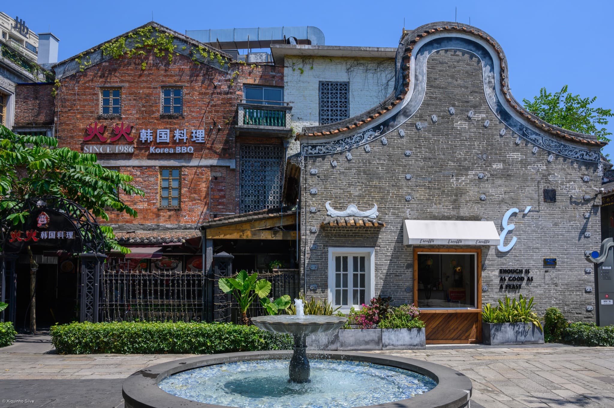 Restored grey-brick buildings, shops and a fountain in Lingnan Tiandi
