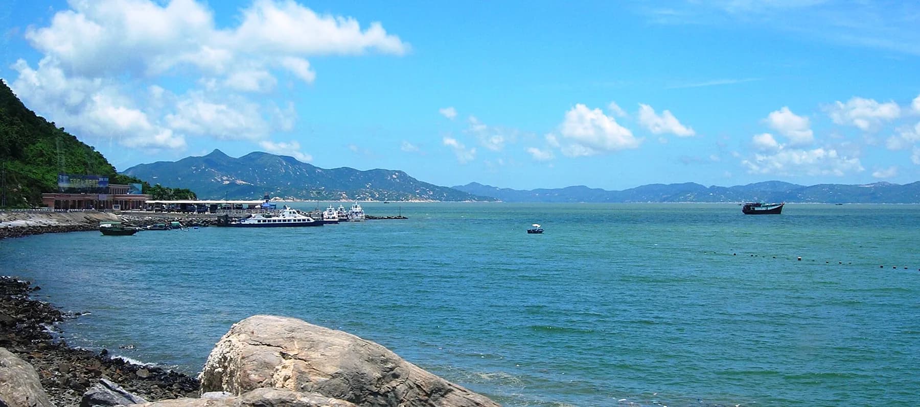 Harbour and boats seen across Wangfuzhou Bay on Xiachuan Island