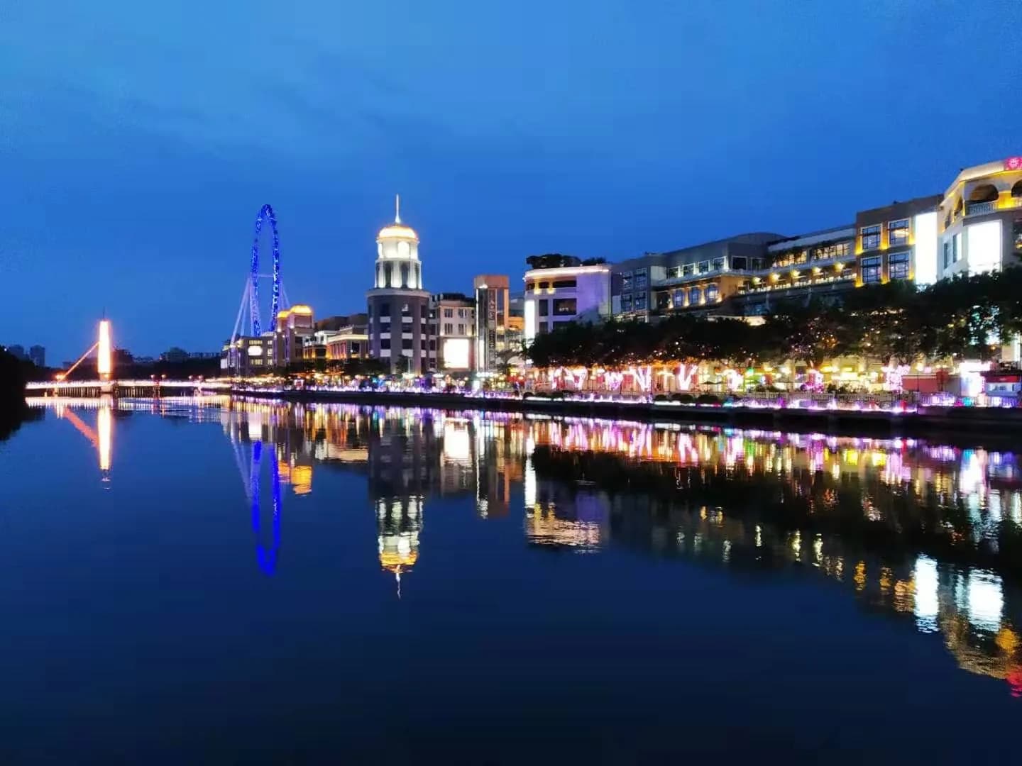 Downtown Zhongshan buildings and lights reflected in the river at blue hour