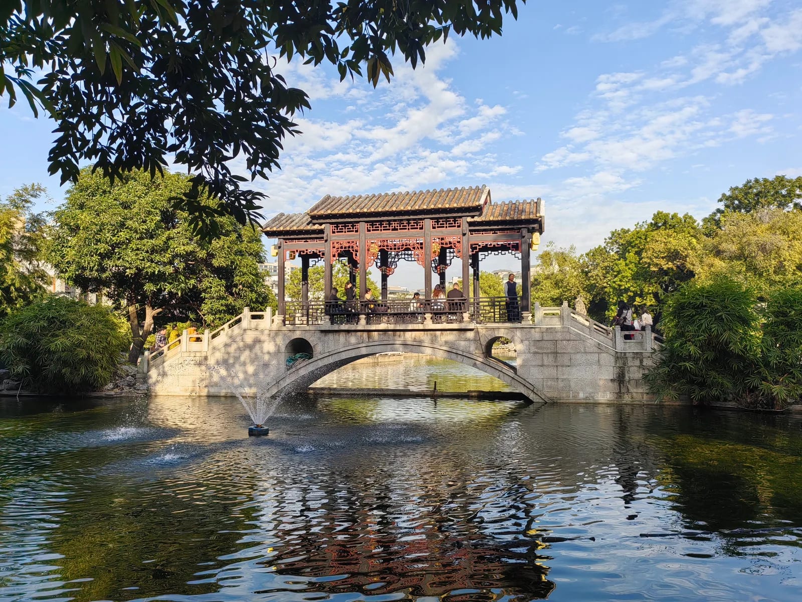 Covered bridge pavilion over the pond at Liang Garden