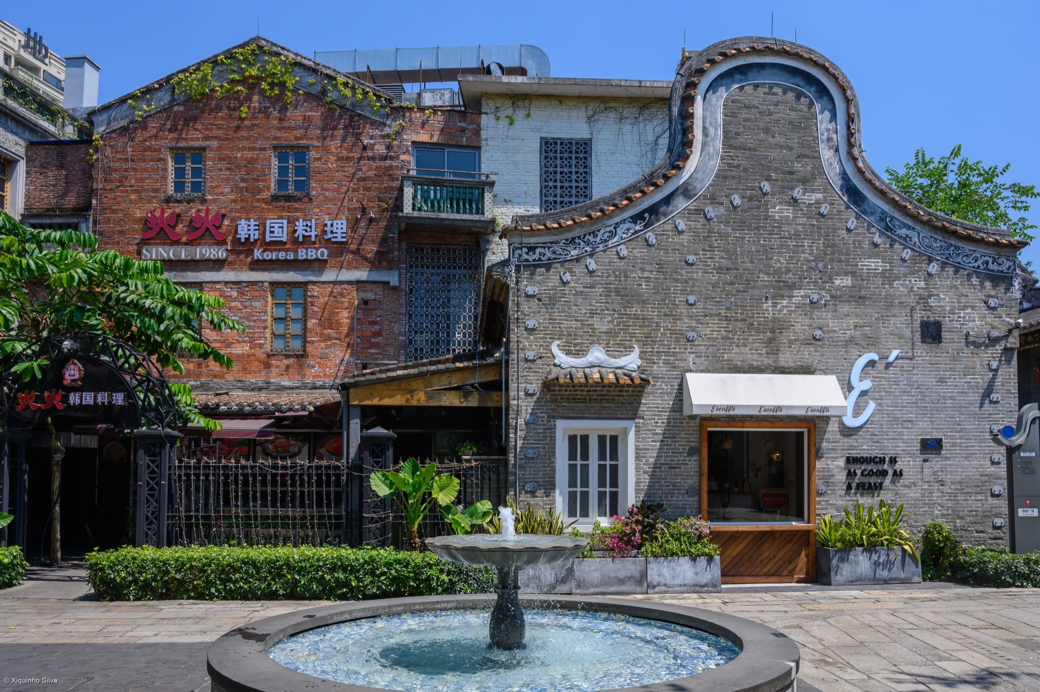 Restored grey-brick buildings, shops and a fountain in Lingnan Tiandi