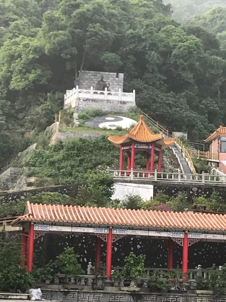 Temple terraces and wooded slopes at Luofu Mountain