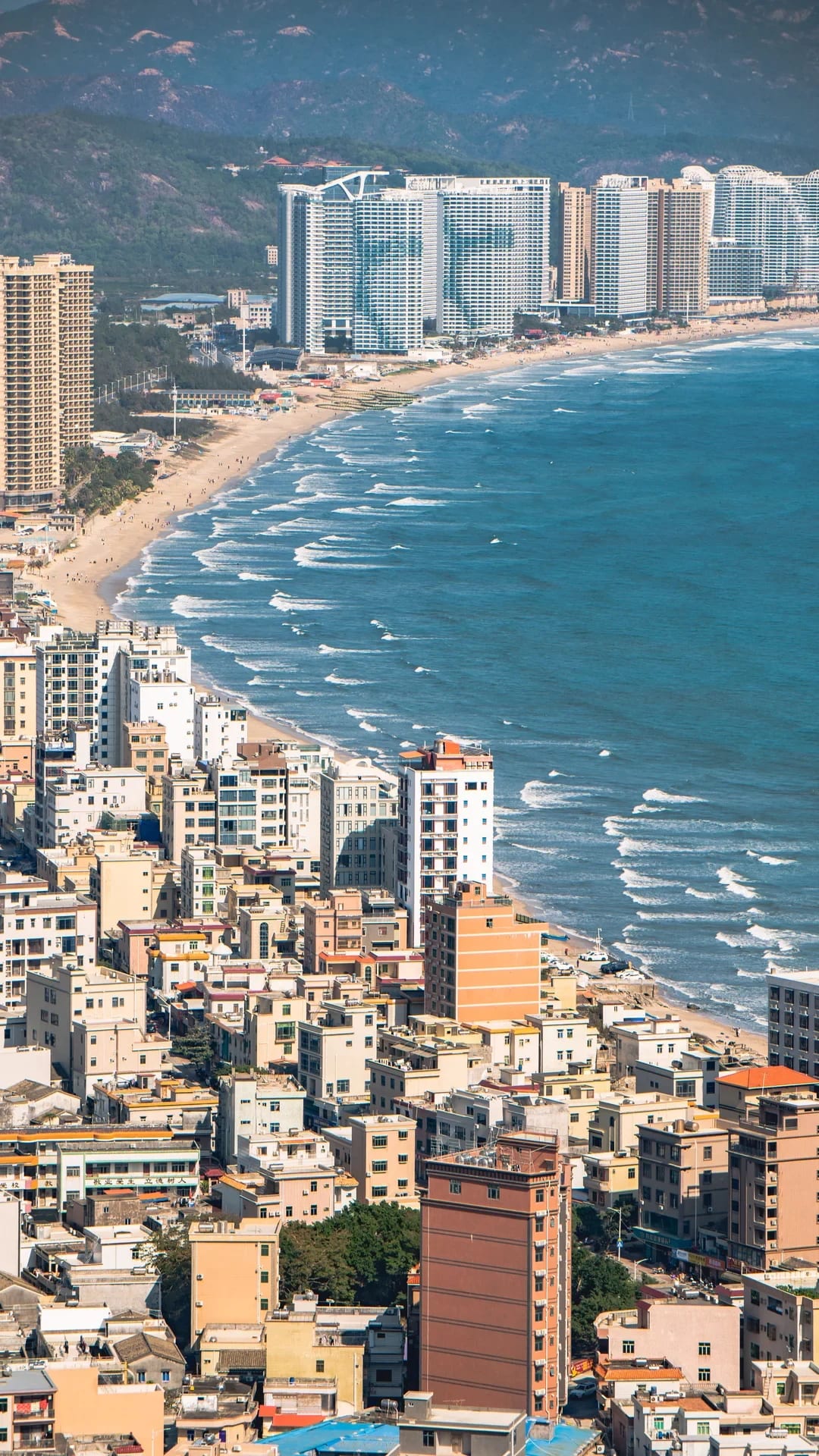 The curving shoreline and coastal buildings at Shuangyue Bay