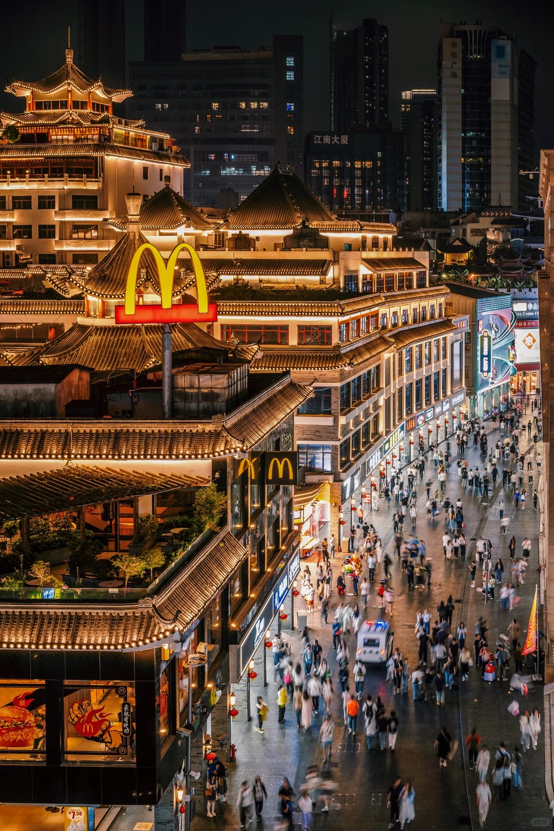 Dongmen Old Street's tiled roofs and busy pedestrian street at night