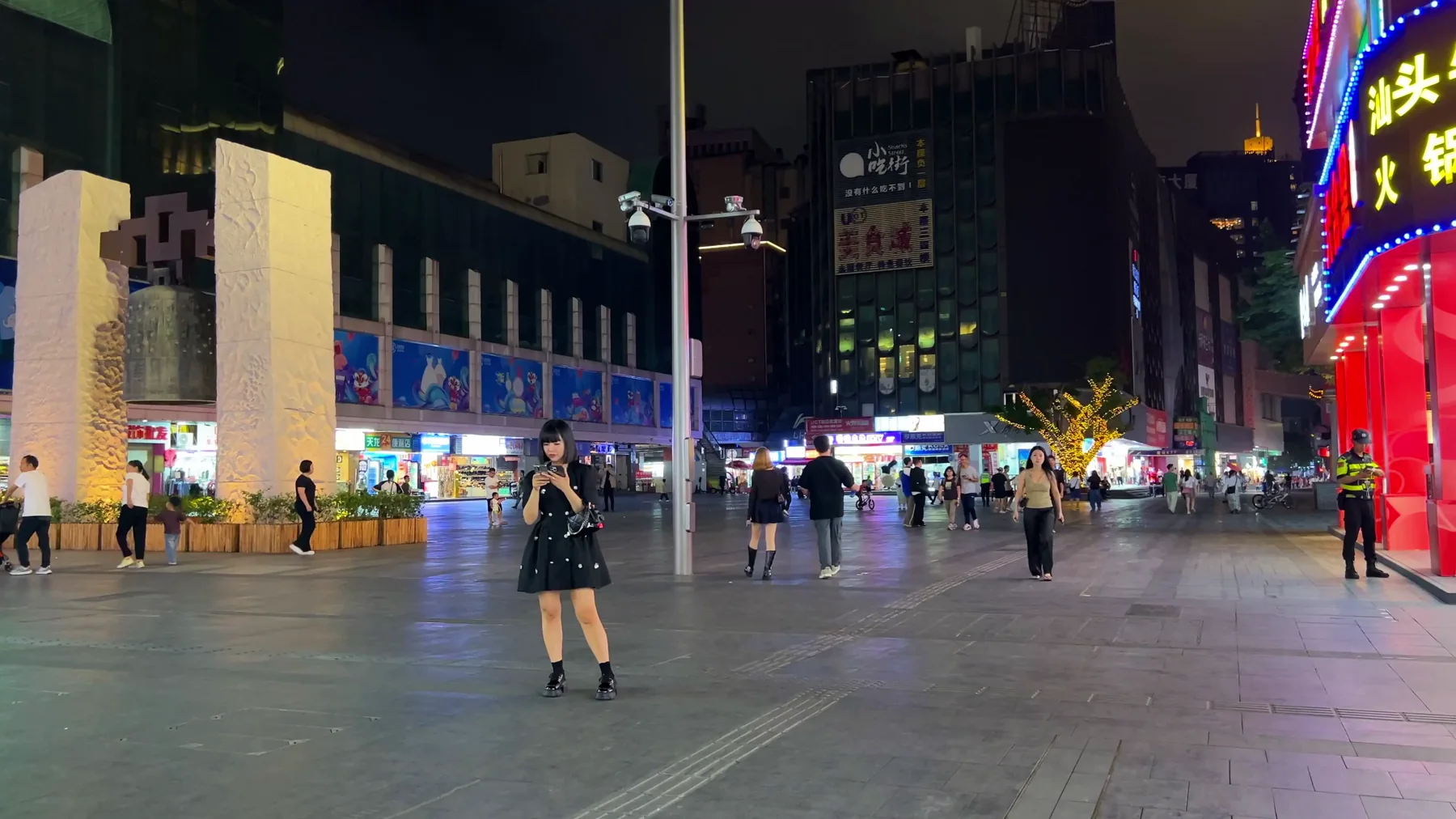 Dongmen Old Street square lit by neon signs at night