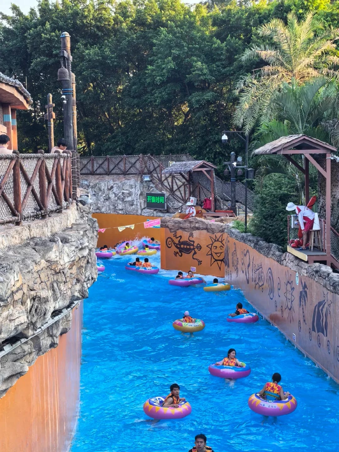 Visitors floating along a channel at Chimelong Water Park