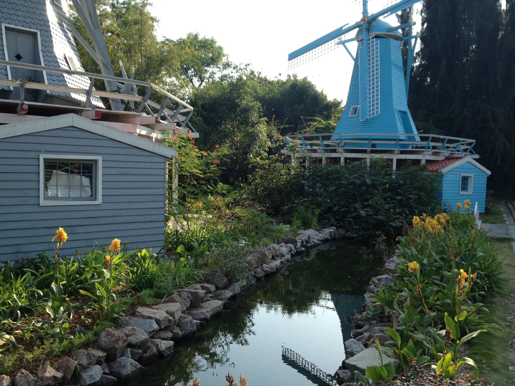 Dutch windmill replicas beside a landscaped canal at Window of the World.
