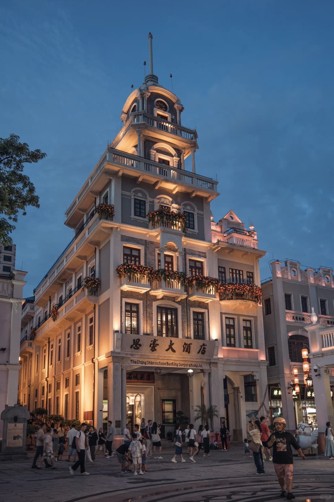 A historic corner building and arcaded street at blue hour on Sunwen West Road, Zhongshan