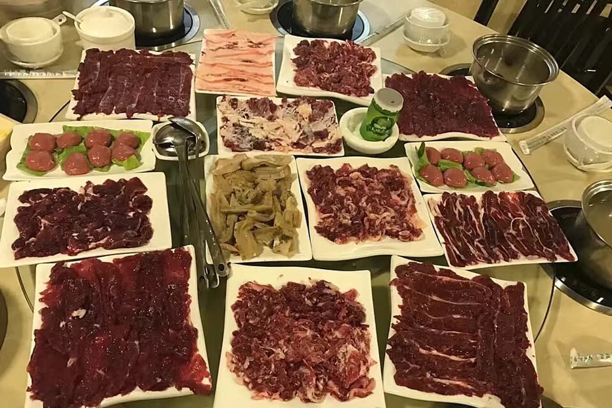 Fresh beef cuts arranged around a Chaoshan hotpot