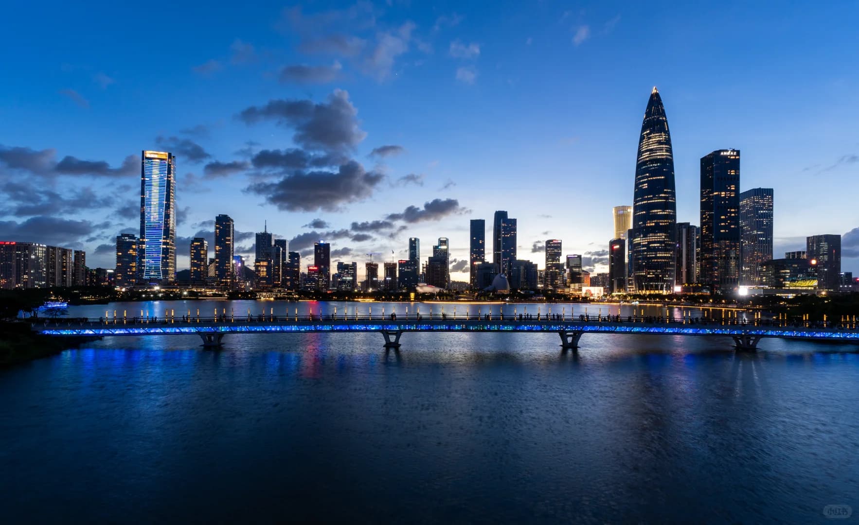 Shenzhen skyline and Houhai Bridge reflected in the water at Talent Park