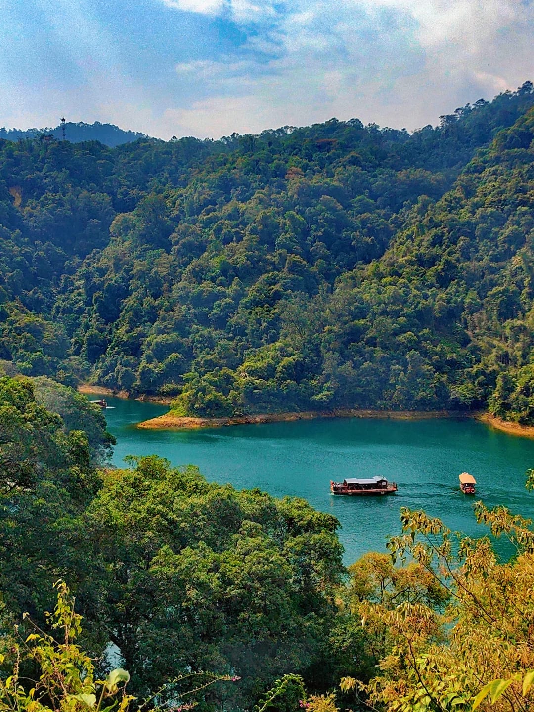High view over Butterfly Valley's turquoise lake and tour boats in Dinghu Mountain