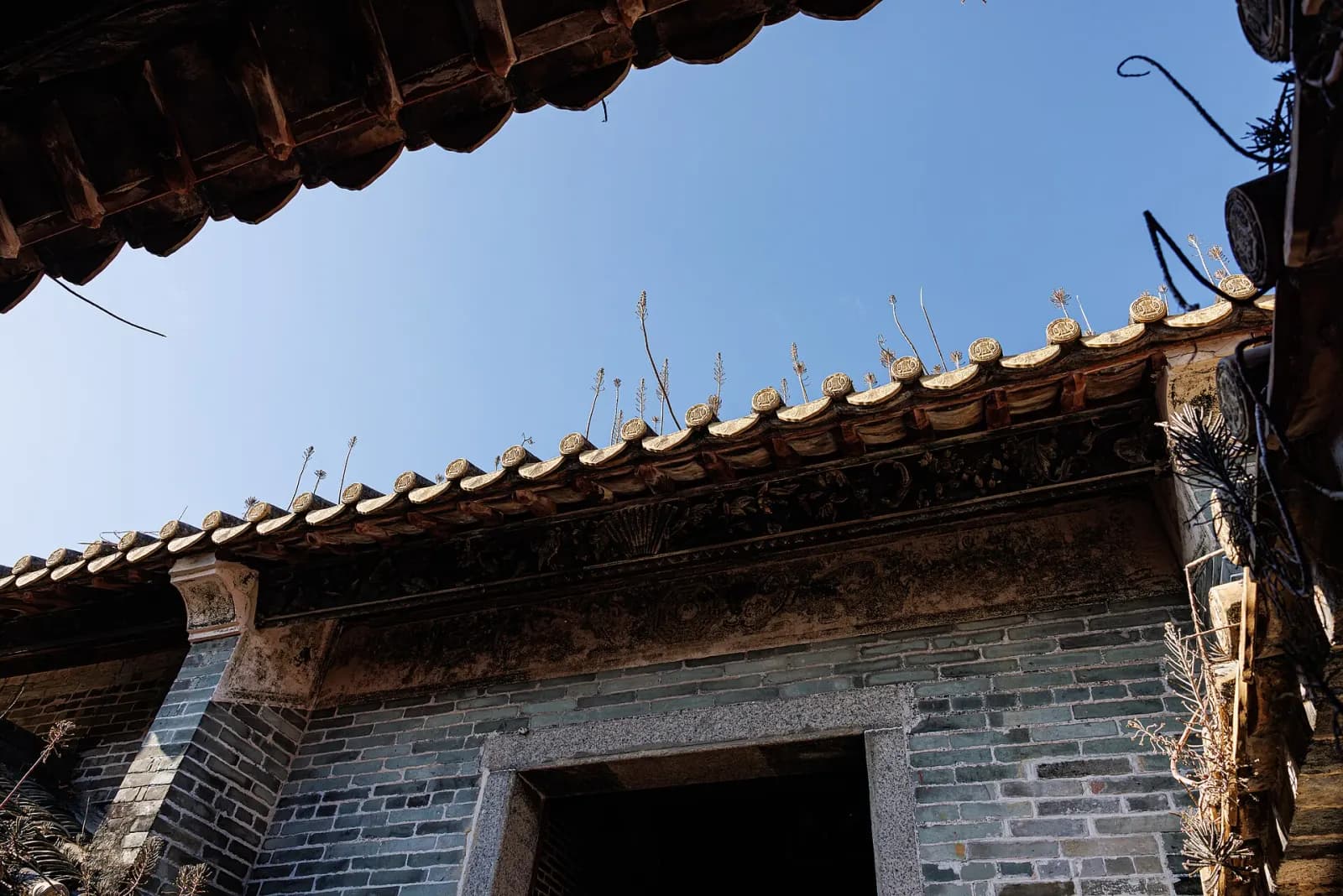Historic walls and tiled buildings inside Dapeng Fortress