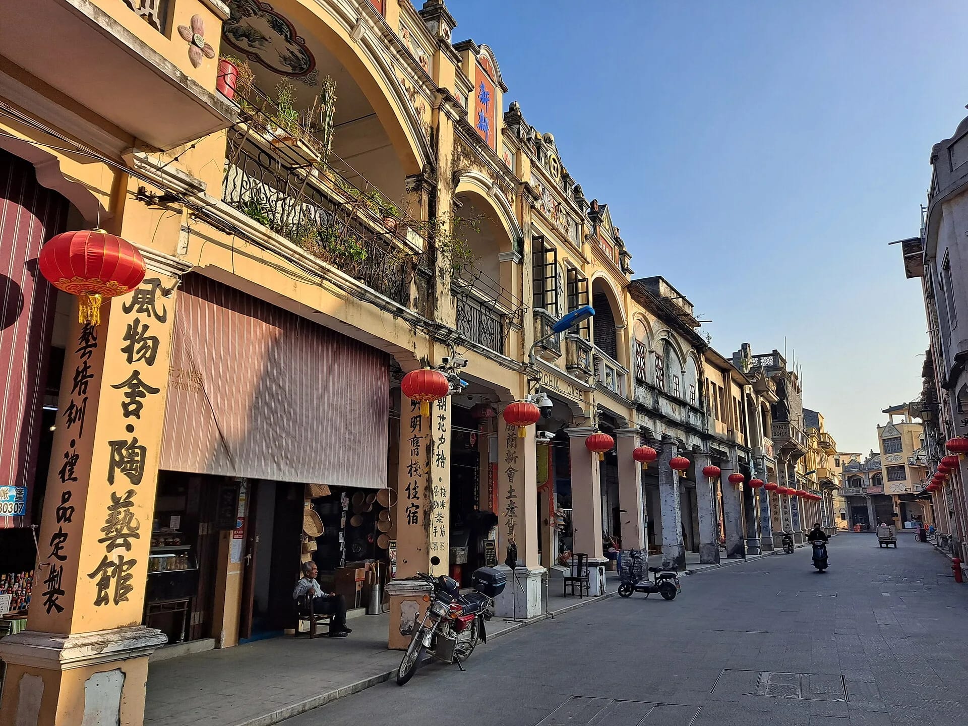 Arcaded shopfronts and local street life on Doumen Old Street